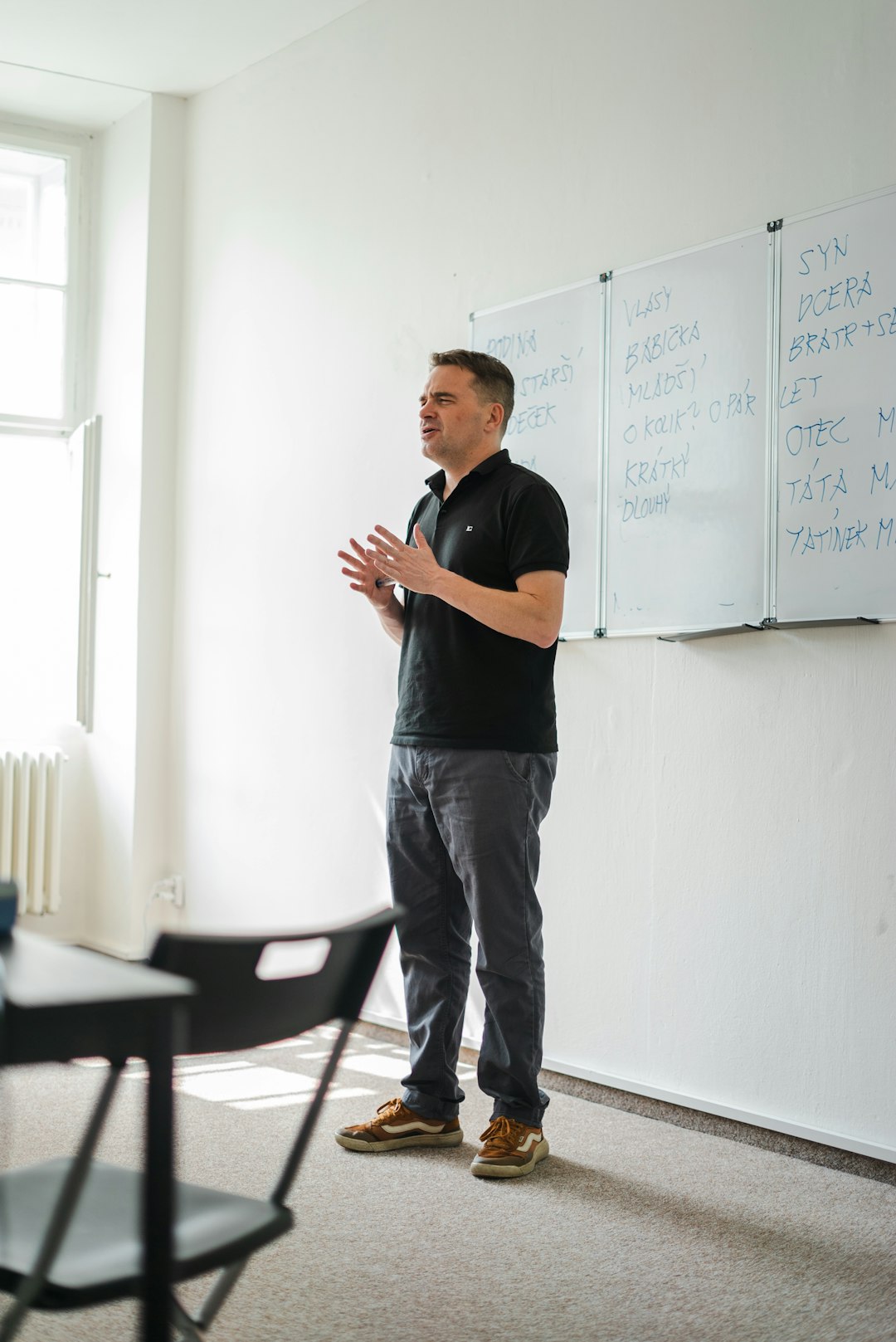 a-person-standing-in-front-of-a-whiteboard-oc7w6fearjs